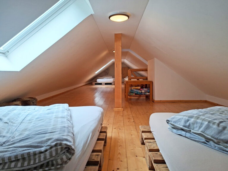 Das Bild zeigt das 4-Bett Schlafzimmer im Dach der Obergeschoss Ferienwohnung in der Luxusboofe in Königstein